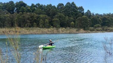 person with sailing boat in lake