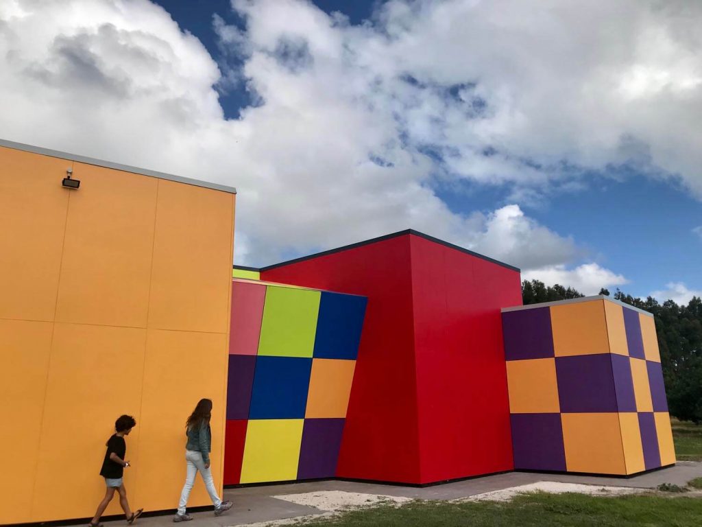 people walking along colourful constructions