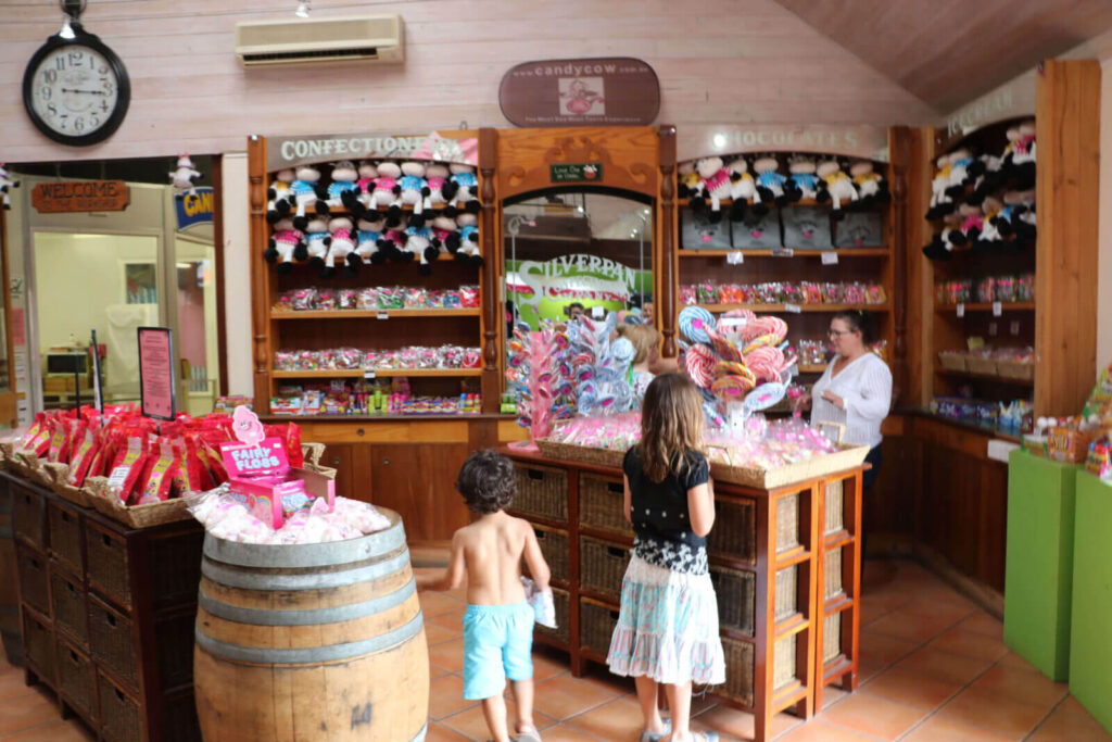 horse back riding Margaret River kids standing in a candy shop in Cowaramup - one of the best things to do in Margaret River with kids