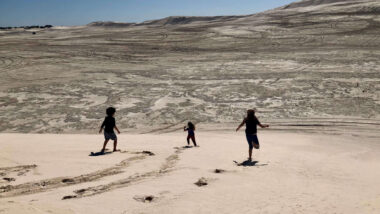 best things to do in lancelin: people in the sand dunes