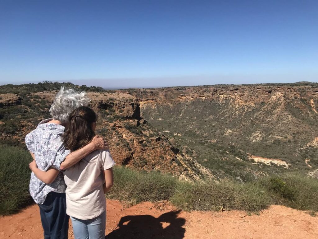 a grandmother and granddaughter looking at the view of Cape Range National Park