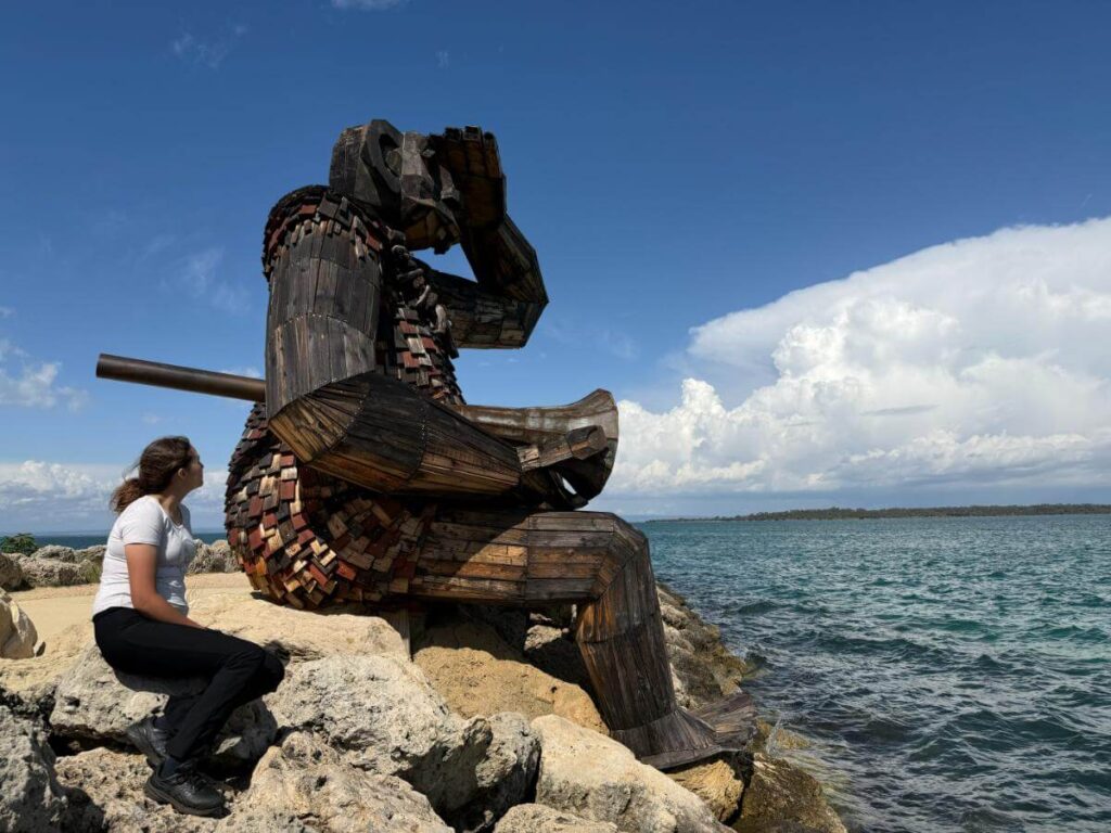Sitting on a rock looking out to sea with one of the Giants of Mandurah, things to do in Mandurah WA